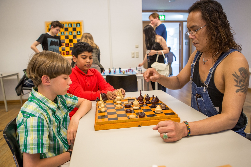 Hamburger Kids lieben Makruk: der spätere Drittplatzierte Konrad-Leo Adler (li.) gegen den gebürtigen Thailänder Sumet 'Thon' Kraiphlaeng (re.), unter dem kritischen Blick des angehenden Memorial-Vize-Champions Ghreesham Manjunath (in der Mitte). Foto: Christoph Harder